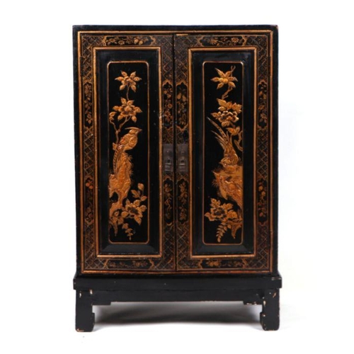 1023 - A chinoiserie two-door side cabinet decorated with birds and foliage, 54cm wide.