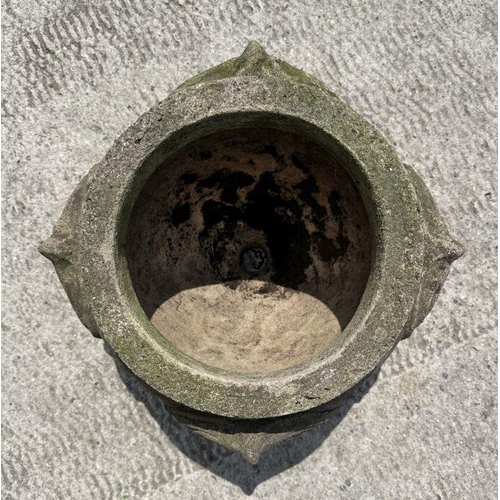 11 - A reconstituted stone planter decorated with roundels, 36cm diameter.