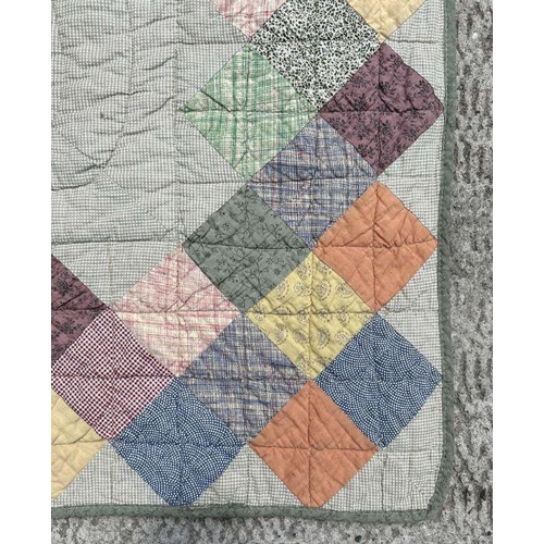 119 - A large fabric bed quilt with geometric design, 270cm by 255cm