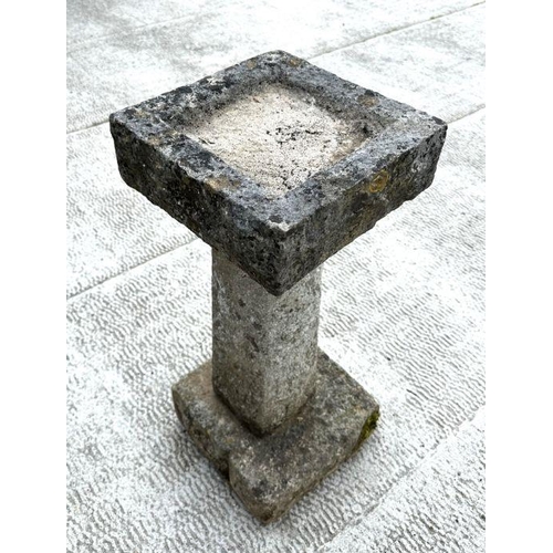 14 - A well weathered carved stone bird bath with square top, on a tapering square column, 64cm high, 32c... 