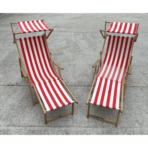 4 - A pair of traditional canvas deckchairs with matching foot stools (4).