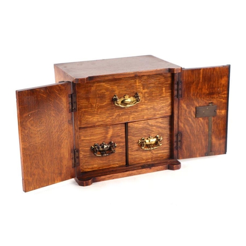 506 - A late Victorian / early Edwardian oak table to safe box, having twin doors opening to reveal three ... 