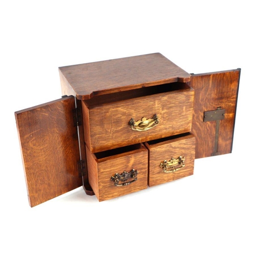 506 - A late Victorian / early Edwardian oak table to safe box, having twin doors opening to reveal three ... 