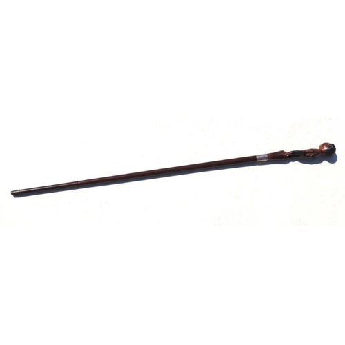 516 - A 19th century mahogany walking stick with figural handle depicting a young boy wearing ragged cloth... 