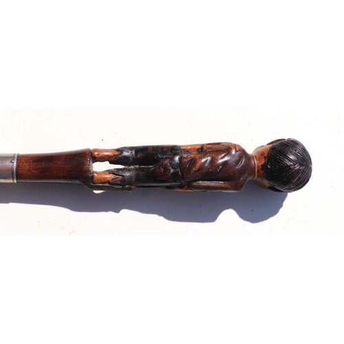 516 - A 19th century mahogany walking stick with figural handle depicting a young boy wearing ragged cloth... 