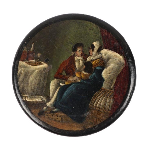 558 - An early 19th century papier-mâché snuff box of compressed circular form, the top decorated with a y... 