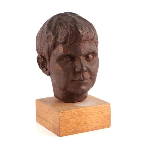 598 - Beryl de Brett (modern British) - a bronzed clay bust of a young boy, (the artist's son) mounted on ... 