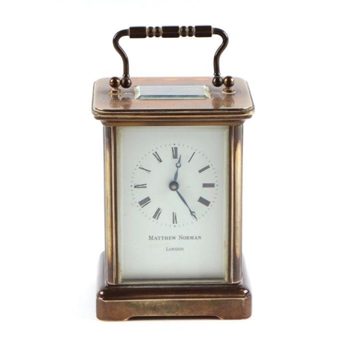 631 - A four pillar brass carriage clock, the white enamel dial with Roman numerals, signed 'Matthew Norma... 