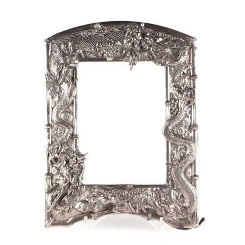 656 - A Chinese silver plated photo frame decorated with embossed scrolling dragons and other mythical bea... 