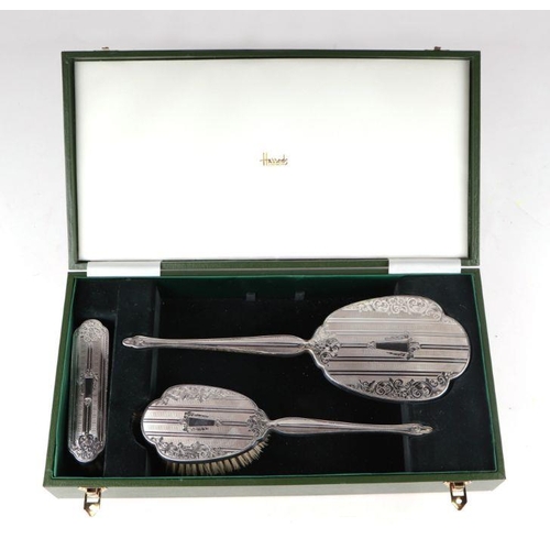 663 - A late 20th century silver three-piece dressing table set, Birmingham 1990, retailed by Harrods Lond... 