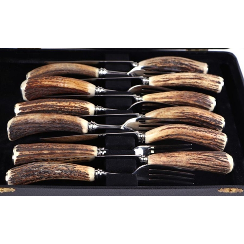 664 - A set of six antler handled steak knives & forks, cased; together with a set of six butter knive... 