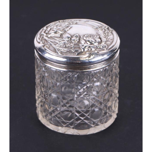 678 - An Edwardian cut glass and silver topped cosmetic jar with repoussé floral decoration, Birmingham 19... 