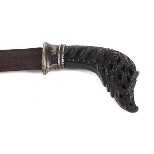 68 - A Pedang sword of Islamic Sumatra, the finely carved horn hilt with silver alloy mounts and slightly... 