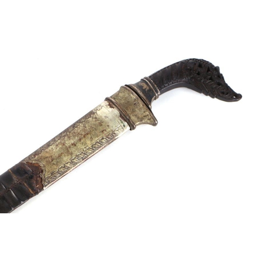 68 - A Pedang sword of Islamic Sumatra, the finely carved horn hilt with silver alloy mounts and slightly... 