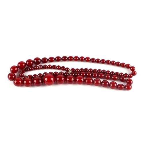 713 - A graduated cherry amber bead necklace, 48g, approx 72cm long.