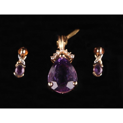 717A - A 14ct gold amethyst and diamond set suite, comprising of pendant and matching earrings