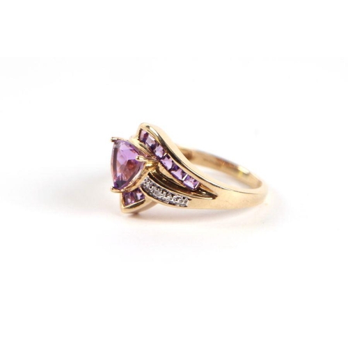 729 - A 9ct gold amethyst and diamond crossover ring with central heart shaped stone, approx UK size 'N', ... 