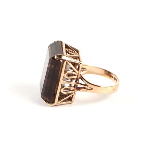 741 - A 9ct gold and emerald cut smoky quartz dress ring, approx UK size 'J', 9g.