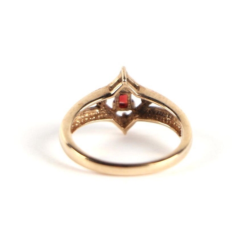 747 - A 9ct gold red stone and diamond ring, the central emerald cut red stone flanked by four small diamo... 