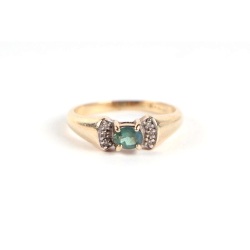 750 - A 9ct gold green stone and diamond bow tie form dress ring, approx UK size 'N', 3g.