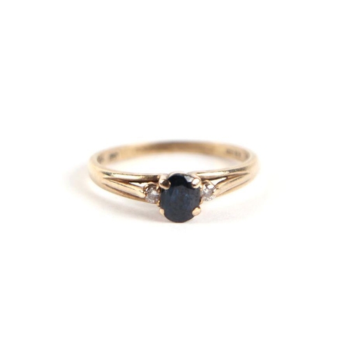 751 - A 9ct gold sapphire and diamond ring, the central sapphire flanked by diamonds, approx UK size 'L', ... 