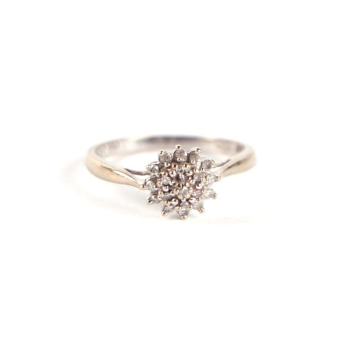 752 - A 9ct white gold and diamond flower head cluster ring, approx UK size 'L', 2g.