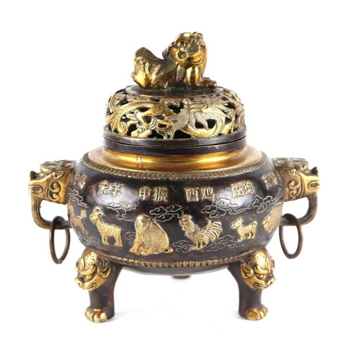 755 - A Chinese bronze censer and cover, the cover having a Fo dog finial, the body having ring handles an... 