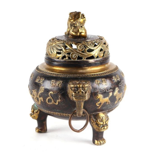 755 - A Chinese bronze censer and cover, the cover having a Fo dog finial, the body having ring handles an... 