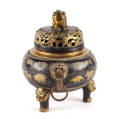 755 - A Chinese bronze censer and cover, the cover having a Fo dog finial, the body having ring handles an... 