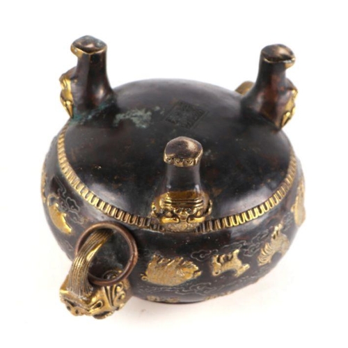 755 - A Chinese bronze censer and cover, the cover having a Fo dog finial, the body having ring handles an... 