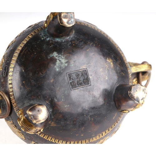 755 - A Chinese bronze censer and cover, the cover having a Fo dog finial, the body having ring handles an... 