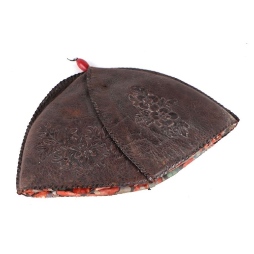 781 - A Chinese leather hat with embossed decoration