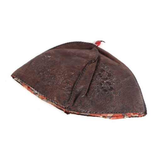 781 - A Chinese leather hat with embossed decoration