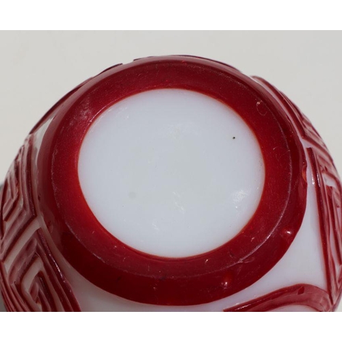 788 - A Chinese red overlay Peking glass ginger jar and cover, 15cms high.