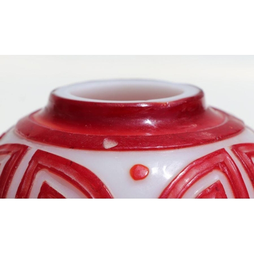 788 - A Chinese red overlay Peking glass ginger jar and cover, 15cms high.