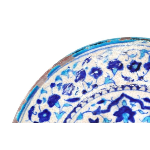 804 - An Iznik pottery charger with traditional blue and turquoise decoration, 36cm diameter.