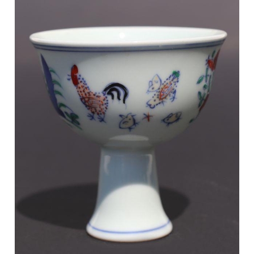 811 - A Chinese porcelain stem cup decorated with cockerels, chicks and flowers, 8.5cm diameter.