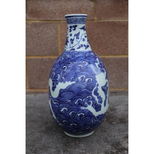 814 - A Chinese blue & white vase decorated with dragons amongst waves, four character mark to side, 2... 