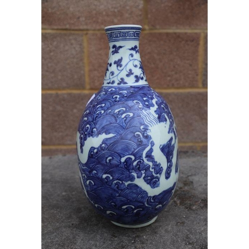 814 - A Chinese blue & white vase decorated with dragons amongst waves, four character mark to side, 2... 