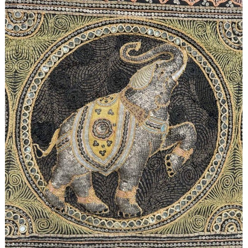 830 - A Burmese Kalaga sequined tapestry depicting elephants within roundels, 198cm by 56cm.