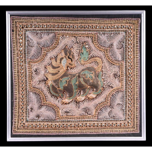 831 - A Burmese Kalaga sequin embroidered tapestry depicting a dragon, framed, 37 by 35cm.