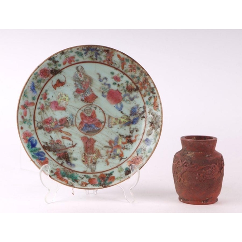 837 - A Chinese Canton Export famille rose plate decorated with figures and precious objects, on a celadon... 