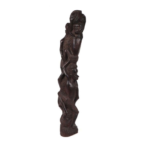 84 - An African tribal carved ebony fertility group of intertwined figures, 42cm high.