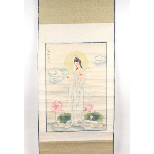 858 - A Chinese scroll painting depicting a bird amongst water lilies, 140cm high.