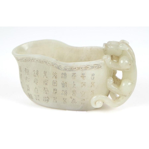 868 - A late Chinese Republic jade vessel decorated with calligraphy and having a carved dragon handle, 13... 