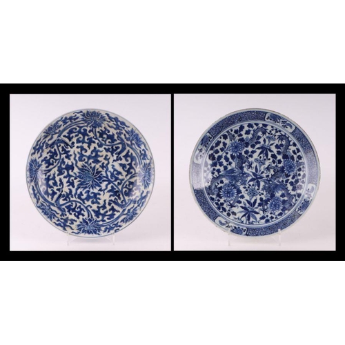 881 - A large Chinese blue and white shallow bowl decorated with flowering foliage, six character mark to ... 