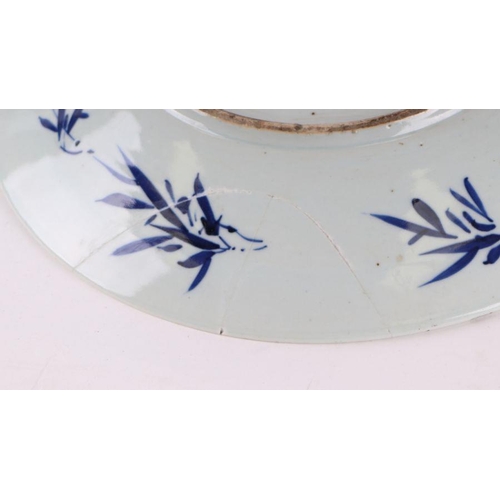 881 - A large Chinese blue and white shallow bowl decorated with flowering foliage, six character mark to ... 