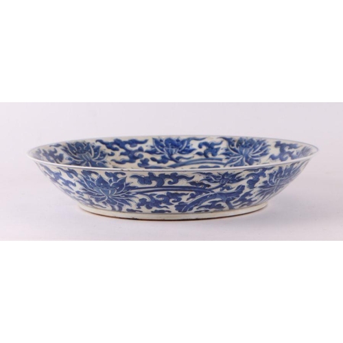 881 - A large Chinese blue and white shallow bowl decorated with flowering foliage, six character mark to ... 