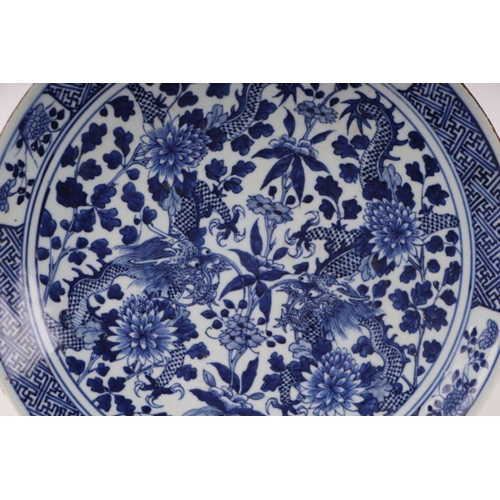 881 - A large Chinese blue and white shallow bowl decorated with flowering foliage, six character mark to ... 