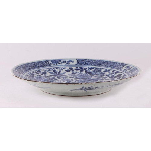 881 - A large Chinese blue and white shallow bowl decorated with flowering foliage, six character mark to ... 